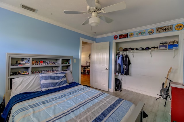 925 SW All American Blvd, Palm City, FL 34990 - bedroom featuring ornamental molding, wood finished floors, a closet, and a ceiling fan