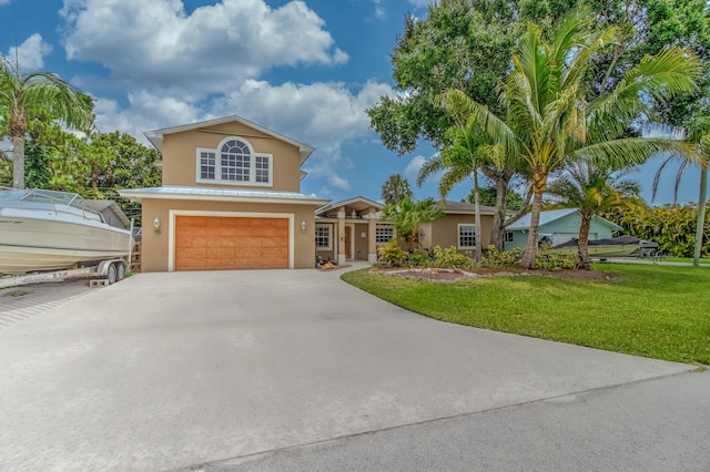 925 SW All American Blvd, Palm City, FL 34990 - view of front facade with stucco siding, an attached garage, a front lawn, and concrete driveway
