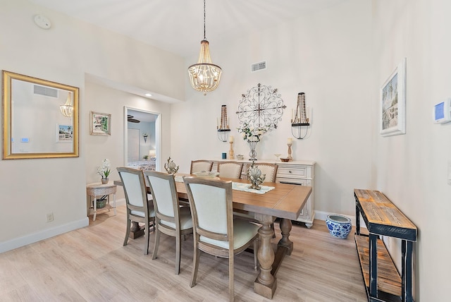 3596 Freshwater Dr, Jupiter, FL 33477 - dining area with light wood-type flooring and a chandelier