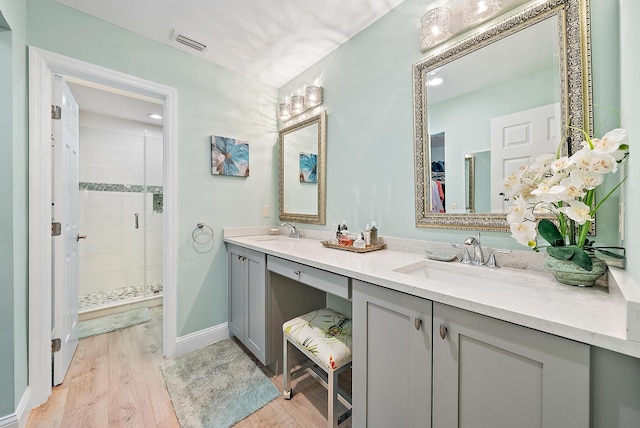 3596 Freshwater Dr, Jupiter, FL 33477 - full bath with double vanity, a stall shower, and wood finished floors