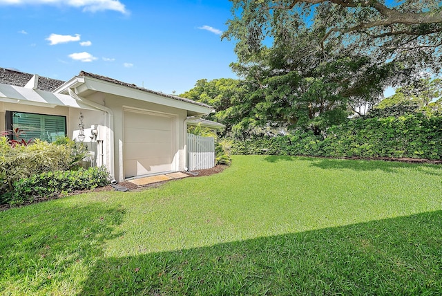 3596 Freshwater Dr, Jupiter, FL 33477 - view of green lawn with an attached garage