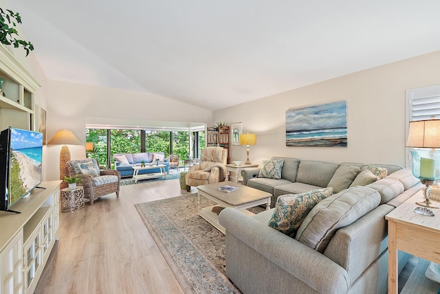 3596 Freshwater Dr, Jupiter, FL 33477 - living room featuring light wood-style flooring and vaulted ceiling