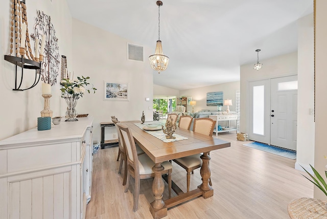3596 Freshwater Dr, Jupiter, FL 33477 - dining room with light wood finished floors, a chandelier, and lofted ceiling