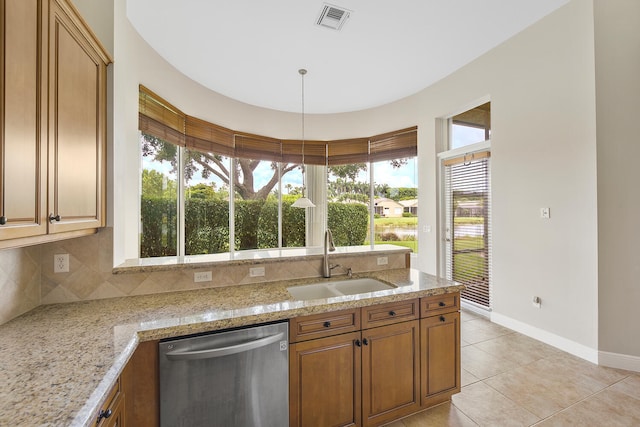 9724 Via Grandezza, Wellington, FL 33411 - kitchen with dishwasher, healthy amount of natural light, light tile patterned floors, and light stone counters