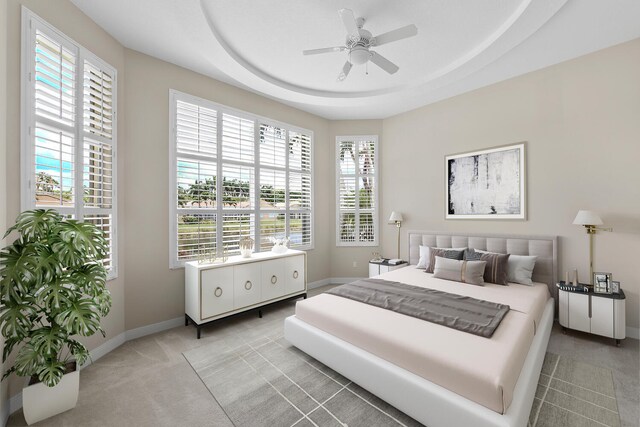 9724 Via Grandezza, Wellington, FL 33411 - bedroom with light colored carpet, a raised ceiling, and a ceiling fan