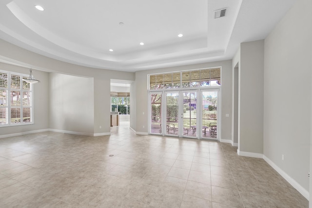 9724 Via Grandezza, Wellington, FL 33411 - spare room with a raised ceiling, recessed lighting, and light tile patterned floors