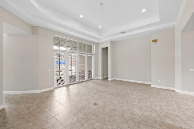 9724 Via Grandezza, Wellington, FL 33411 - unfurnished room with a tray ceiling, recessed lighting, and light tile patterned floors