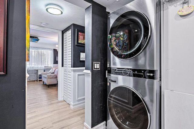 1605 S US Highway 1 Unit F202, Jupiter, FL 33477 - laundry area featuring stacked washing machine and dryer and wood finished floors