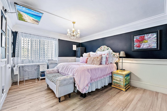 1605 S US Highway 1 Unit F202, Jupiter, FL 33477 - bedroom with a chandelier, wood finished floors, ornamental molding, and a wainscoted wall