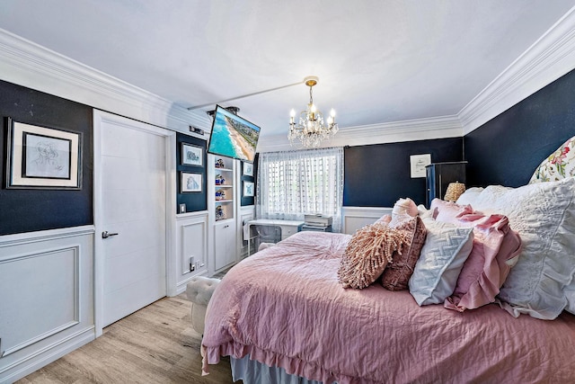 1605 S US Highway 1 Unit F202, Jupiter, FL 33477 - bedroom with a chandelier, ornamental molding, a wainscoted wall, wood finished floors, and a decorative wall