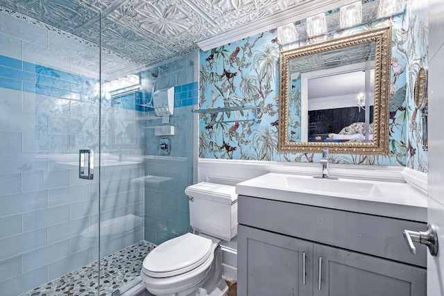 1605 S US Highway 1 Unit F202, Jupiter, FL 33477 - full bathroom with vanity, a stall shower, wallpapered walls, and a wainscoted wall