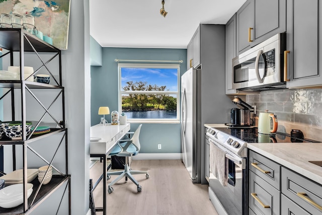 2 Colonial Club Dr Unit 203, Boynton Beach, FL 33435 - kitchen with stainless steel appliances, gray cabinets, light wood-style flooring, and tasteful backsplash