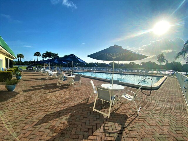 2 Colonial Club Dr Unit 203, Boynton Beach, FL 33435 - community pool featuring a patio