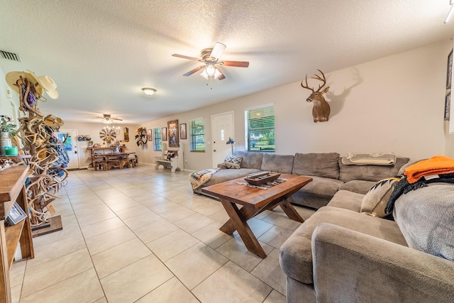 1450 SW 28th St, Okeechobee, FL 34974 - living area with a ceiling fan, light tile patterned flooring, and a textured ceiling