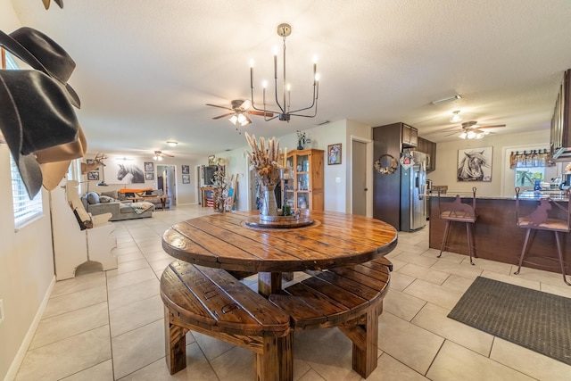 1450 SW 28th St, Okeechobee, FL 34974 - dining area with ceiling fan, light tile patterned floors, healthy amount of natural light, a chandelier, and a textured ceiling