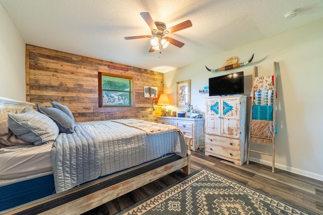 1450 SW 28th St, Okeechobee, FL 34974 - bedroom featuring wood walls, wood finished floors, a textured ceiling, and a ceiling fan