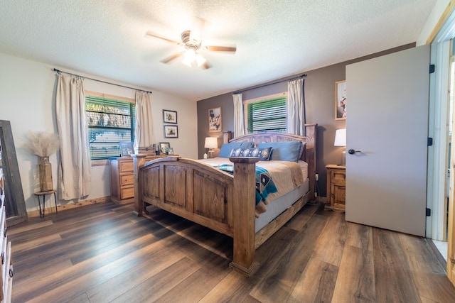 1450 SW 28th St, Okeechobee, FL 34974 - bedroom featuring dark wood-type flooring, a textured ceiling, and ceiling fan