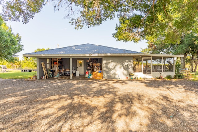 1450 SW 28th St, Okeechobee, FL 34974 - rear view of property with a sunroom and a metal roof