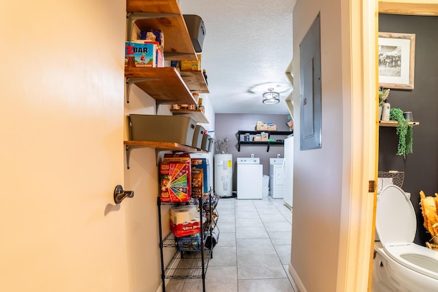 1450 SW 28th St, Okeechobee, FL 34974 - hallway featuring water heater, washing machine and clothes dryer, tile patterned floors, and electric panel