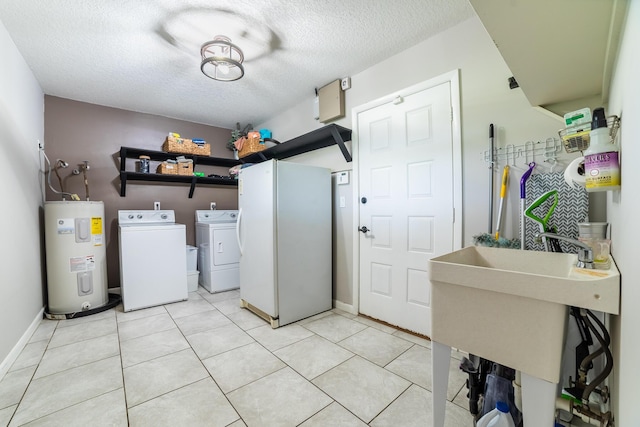 1450 SW 28th St, Okeechobee, FL 34974 - laundry area featuring water heater, washing machine and clothes dryer, a textured ceiling, and light tile patterned floors