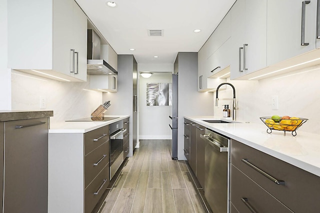 2001 N Ocean Blvd Unit 1804, Boca Raton, FL 33431 - kitchen with appliances with stainless steel finishes, wall chimney range hood, modern cabinets, light countertops, and recessed lighting