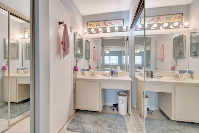 15401 Pembridge Ave Unit 9, Delray Beach, FL 33484 - bathroom featuring two vanities, ceiling fan, and tile patterned flooring