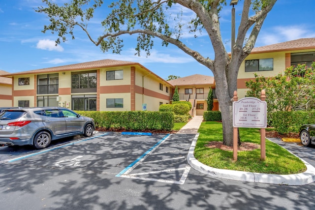 15401 Pembridge Ave Unit 9, Delray Beach, FL 33484 - view of building exterior with uncovered parking