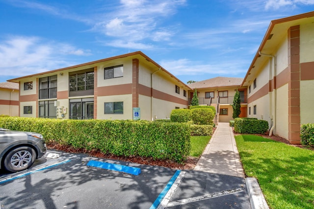 15401 Pembridge Ave Unit 9, Delray Beach, FL 33484 - view of property featuring uncovered parking