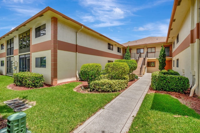15401 Pembridge Ave Unit 9, Delray Beach, FL 33484 - surrounding community featuring stairway and a yard