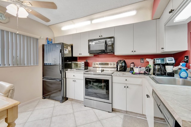 15401 Pembridge Ave Unit 9, Delray Beach, FL 33484 - kitchen featuring black appliances, light countertops, light tile patterned floors, a ceiling fan, and white cabinetry