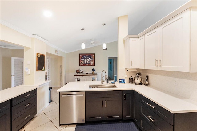 2990 SW Ventura St, Port Saint Lucie, FL 34953 - kitchen with stainless steel dishwasher, a peninsula, white cabinetry, light countertops, and crown molding