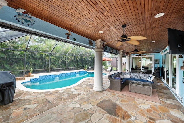 2990 SW Ventura St, Port Saint Lucie, FL 34953 - swimming pool featuring an outdoor hangout area, a patio area, a ceiling fan, and glass enclosure