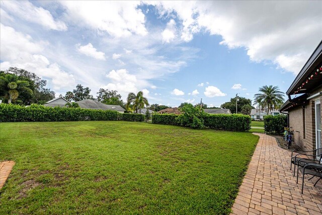 2990 SW Ventura St, Port Saint Lucie, FL 34953 - view of grassy yard with a patio