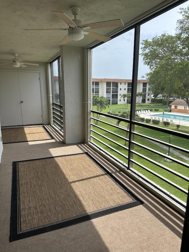 5917 Via Vermilya Unit 306, Lake Worth, FL 33462 - unfurnished sunroom featuring ceiling fan