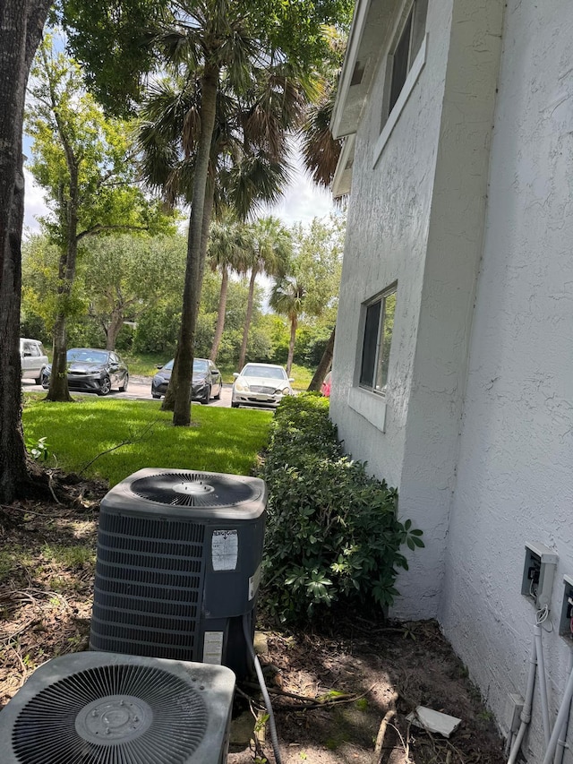 984 Lake Victoria Dr Unit B, West Palm Beach, FL 33411 - exterior view of stucco siding and a cooling unit