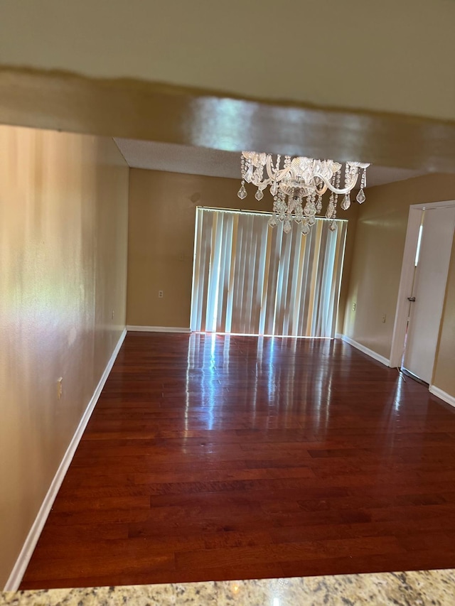 984 Lake Victoria Dr Unit B, West Palm Beach, FL 33411 - empty room with a chandelier and wood finished floors