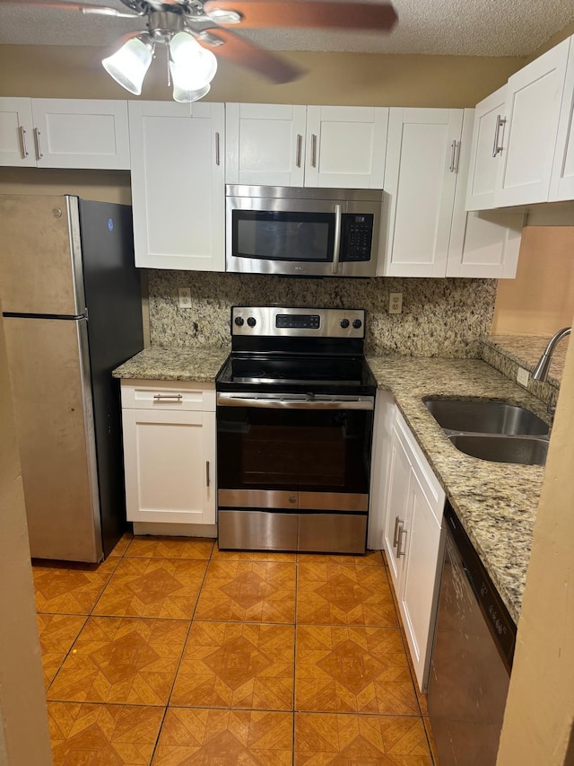 984 Lake Victoria Dr Unit B, West Palm Beach, FL 33411 - kitchen with appliances with stainless steel finishes, a ceiling fan, and white cabinets