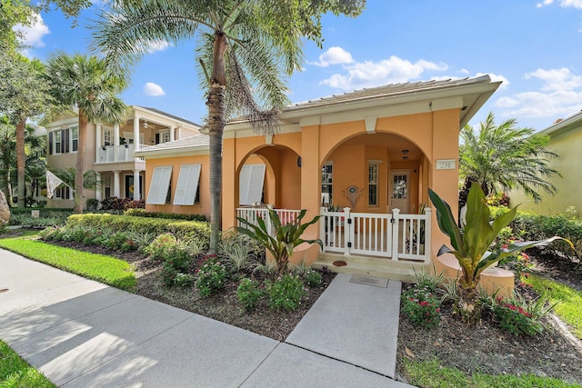 231 Caravelle Dr, Jupiter, FL 33458 - mediterranean / spanish-style home with covered porch and stucco siding