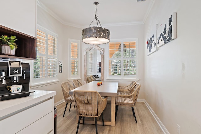 231 Caravelle Dr, Jupiter, FL 33458 - dining space with light wood-style flooring and crown molding