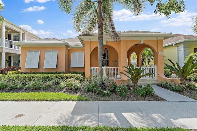 231 Caravelle Dr, Jupiter, FL 33458 - view of front of property with covered porch and stucco siding