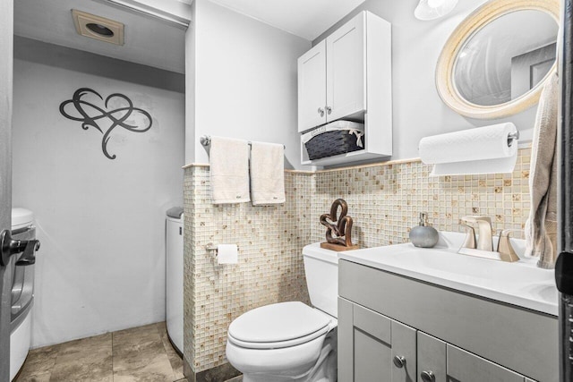 22180 Boca Rancho Dr Unit B, Boca Raton, FL 33428 - half bath with tile walls, vanity, and wainscoting