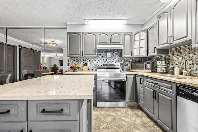 22180 Boca Rancho Dr Unit B, Boca Raton, FL 33428 - kitchen featuring gray cabinets, stainless steel appliances, under cabinet range hood, a textured ceiling, and decorative backsplash