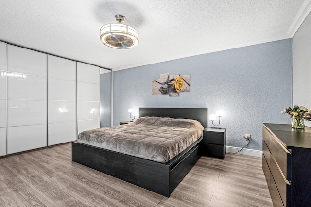 22180 Boca Rancho Dr Unit B, Boca Raton, FL 33428 - bedroom featuring a textured wall, ornamental molding, a textured ceiling, and wood finished floors