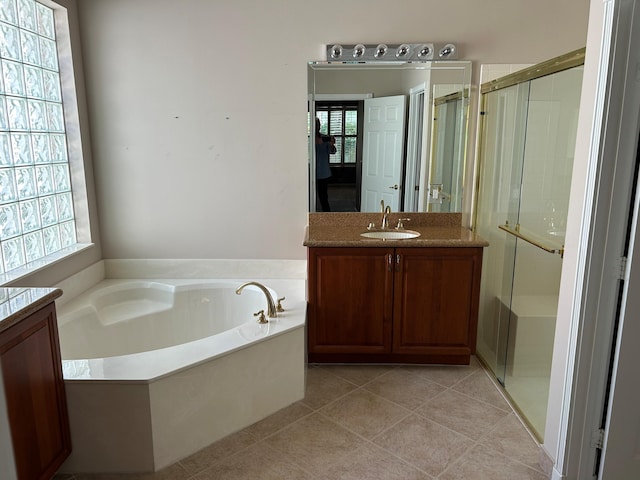 9916 E Tallyrand Dr, Lake Worth, FL 33467 - bathroom featuring vanity, a garden tub, a stall shower, and tile patterned flooring
