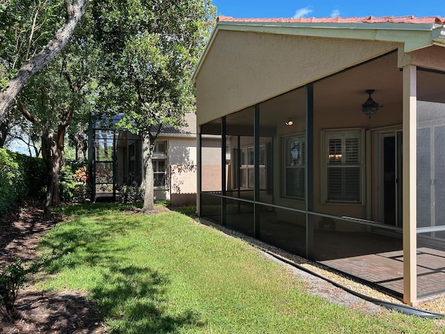 9916 E Tallyrand Dr, Lake Worth, FL 33467 - view of grassy yard with a sunroom