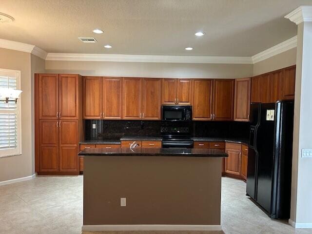 9916 E Tallyrand Dr, Lake Worth, FL 33467 - kitchen featuring black appliances, ornamental molding, dark countertops, brown cabinets, and an island with sink