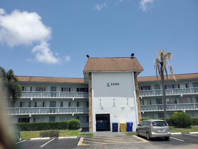 2200 Springdale Blvd Unit 306, Palm Springs, FL 33461 - view of apartment building / complex featuring uncovered parking