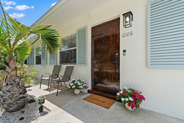1008 Mohawk St, Jupiter, FL 33458 - view of exterior entry featuring stucco siding and covered porch