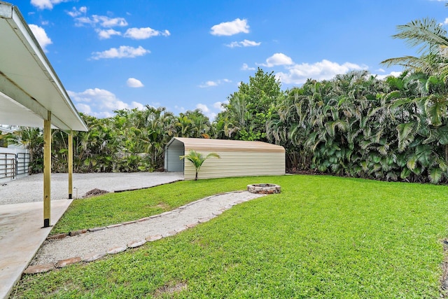1008 Mohawk St, Jupiter, FL 33458 - view of yard featuring an outdoor fire pit and an outbuilding