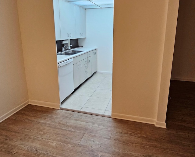 2905 Victoria Pl Unit D3, Coconut Creek, FL 33066 - kitchen with dishwasher, white cabinets, light countertops, and light wood-type flooring